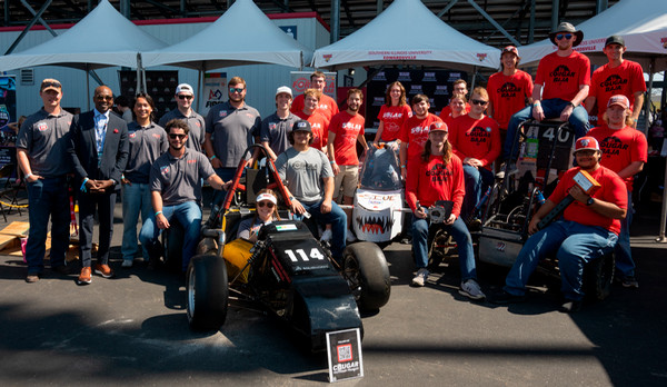 Group photo of SOE student-led racing teams and Chancellor Minor on STEM Lane at World Wide Technology Raceway