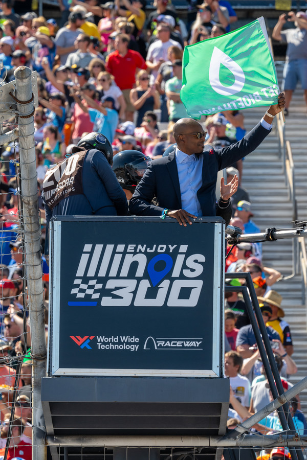 Close Up of Dr Minor on Flagstand waving the green flag to start a NASCAR race