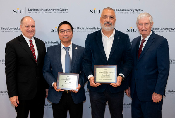 Photo of Mahony, Cho, Onal, and Gilbert with plaques