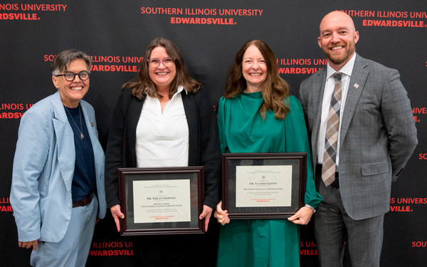 Provost Faculty members and Dean pose with faculty members holding framed awards