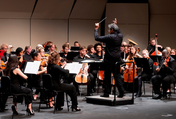 Orchestra and conductor performing on stage
