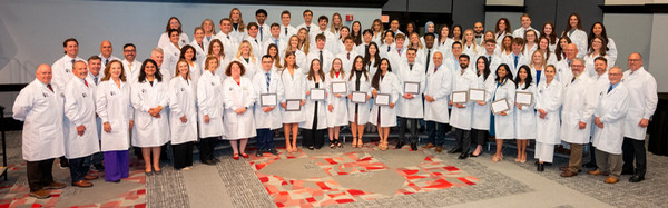 Class Photo with faculty and students on risers for SIU SDM white coat ceremony