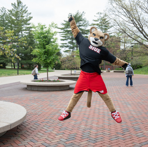 School mascot Eddie is mid jump on Stratton Quad