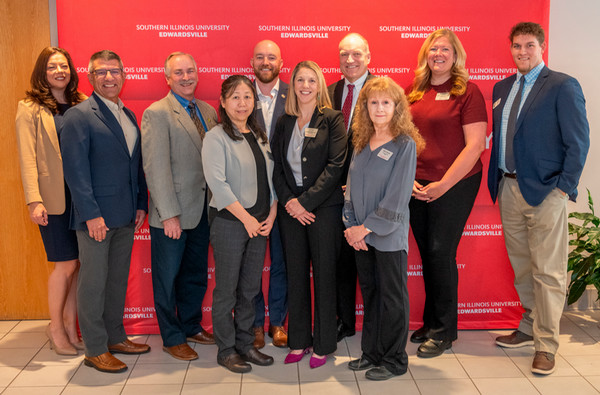 NCERC Staff Partners and Dr Mahony pose in front of SIUE background