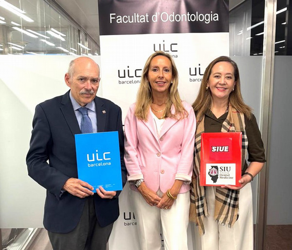 Three faulty members standing to camera holding certificates