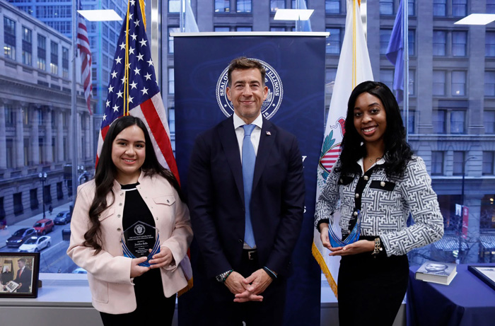 Secretary Giannoulias awards Jocelyn Solis (left) and Amari’ah Carter (right) the 2025 Illinois John Lewis Youth Leadership Award.