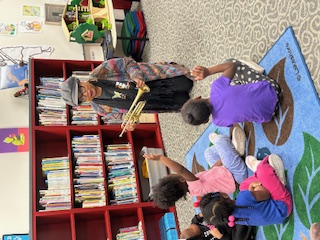 Lauren Davis w trumpet show and tell for young children
