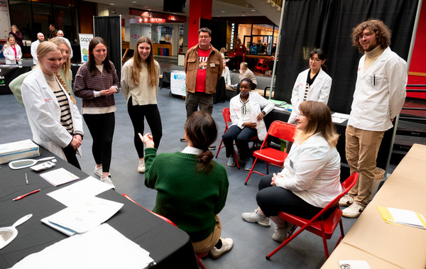 Students stand in a circle in discussion at Diabetes Education Symposium