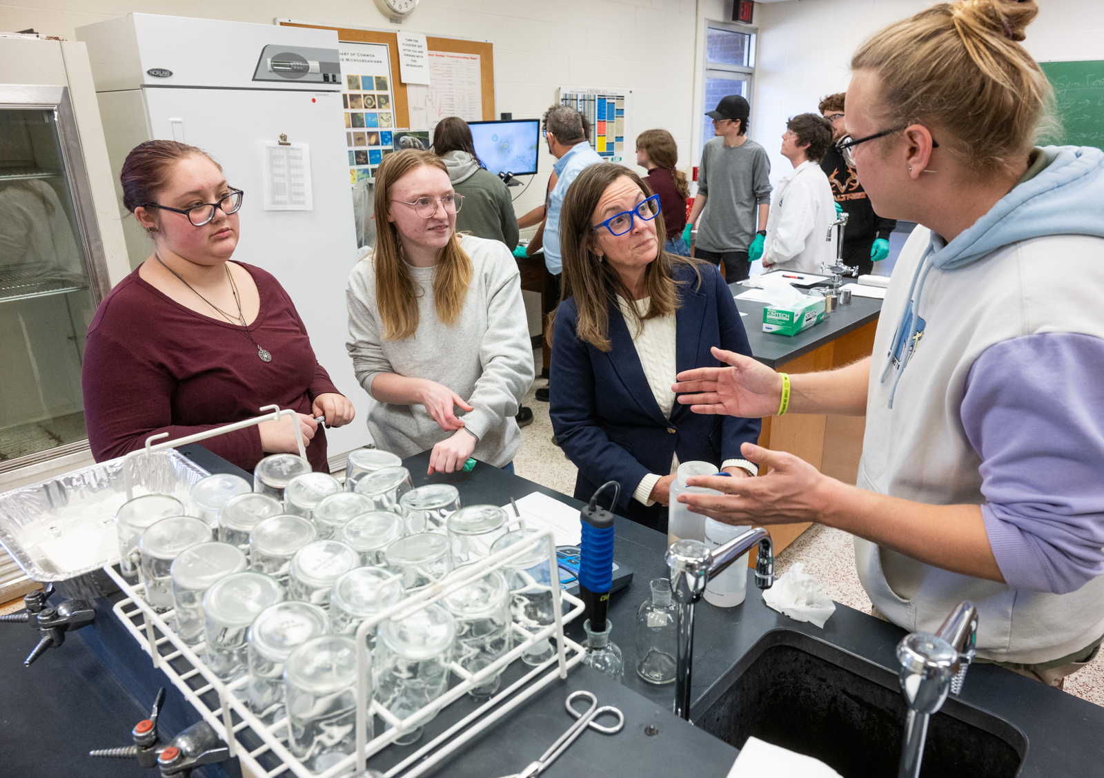 Illinois State Representative Katie Stuart talks with SIUE students in a laboratory at the Environmental Resources Training Center as students demonstrate water and wastewater testing equipment and discuss their coursework.