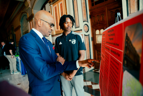 Chancellor Minor admires a visual aid display with student Mihlali Kapatamoyo in the Illinois Capitol Rotunda