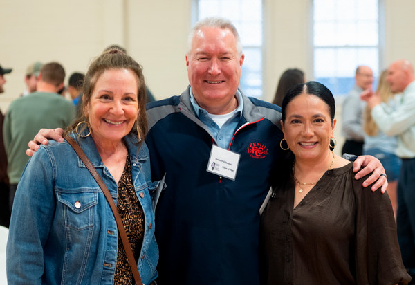 Three SIU SDM alumni pose for camera at brunch