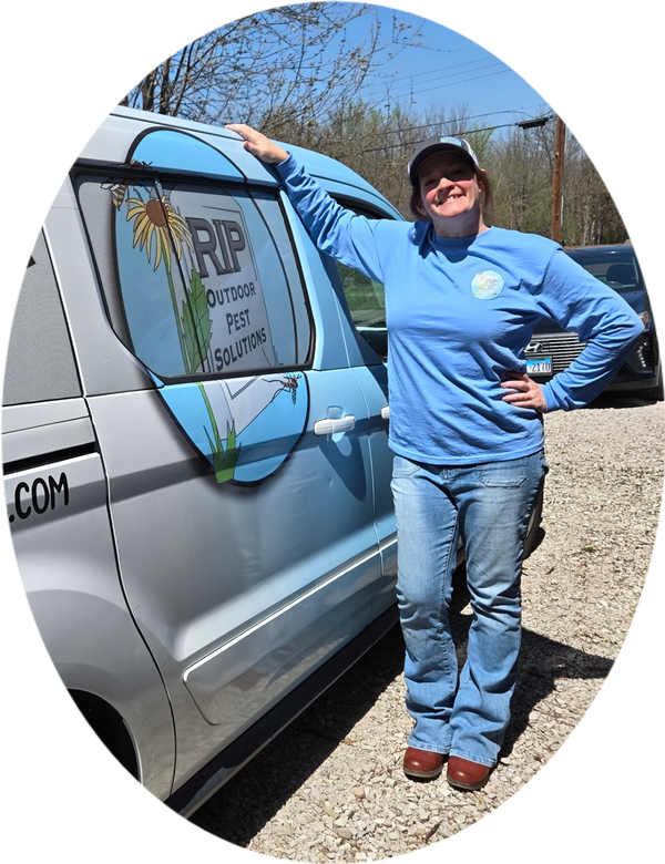 Founder of pest control company standing by her company van