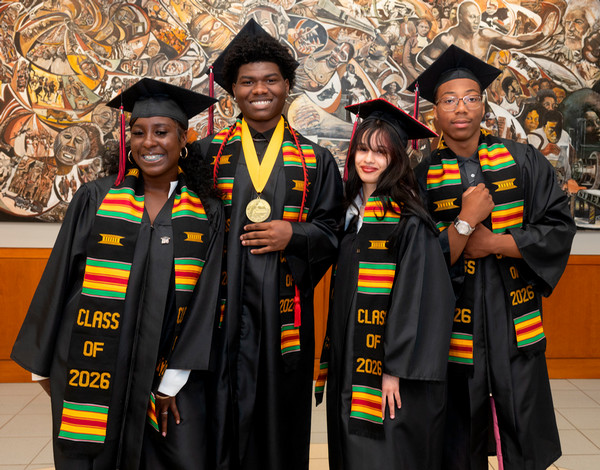 Four Black scholars in academic regalia with stoles representing the class of 2026