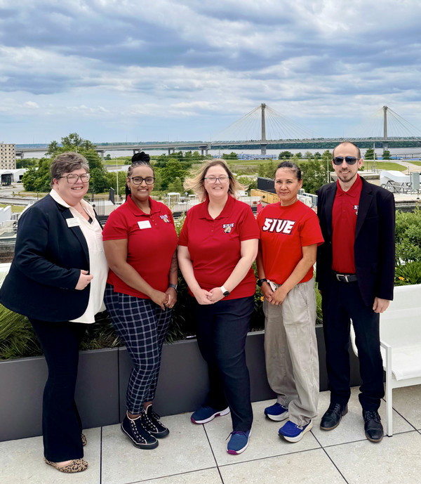 SIUE Team on Rooftop posing for photo in SIUE gear