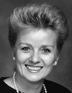 Black-and-white formal portrait of a smiling Wilma Jene Bond. She has short, carefully styled hair, pearl earrings and a pearl necklace, wearing a dark top against a plain background.