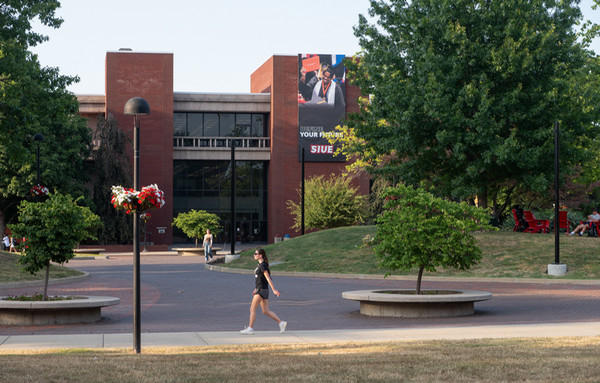 Lovejoy Library exterior with student walking in front