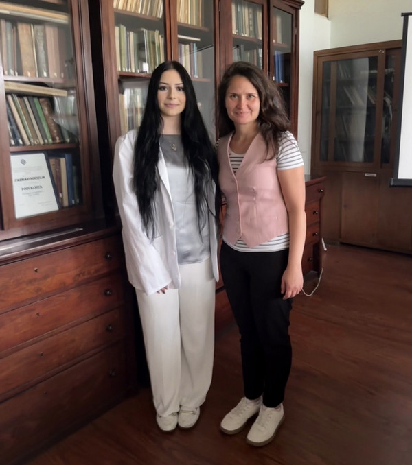 Sofija Prvulov and her professor stand together in university library