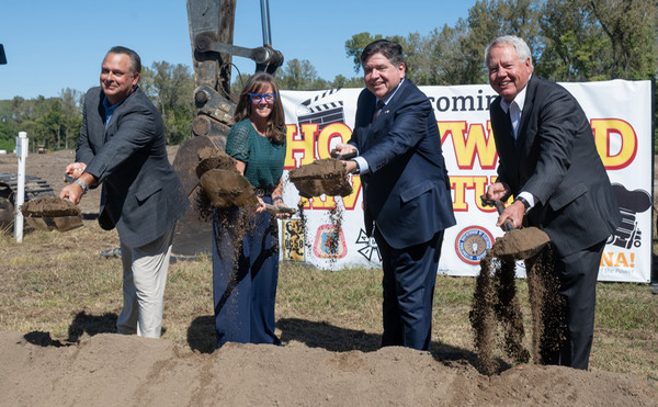 Governor Pritzer studio owner Chris Breakwell and legislators pick up shovels and toss dirt at groundbreaking ceremony in Wood River