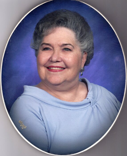 Portrait of Peggy LaRue Kohler wearing a sky blue blouse. She is smiling and the photo has an oval border as a frame.