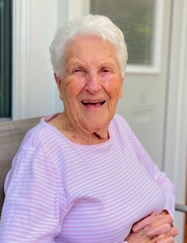 Portrait of a smiling Engleman wearing a lilac striped blouse seated outside