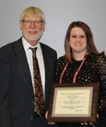 Leslie Brock and LERN representative with the award
