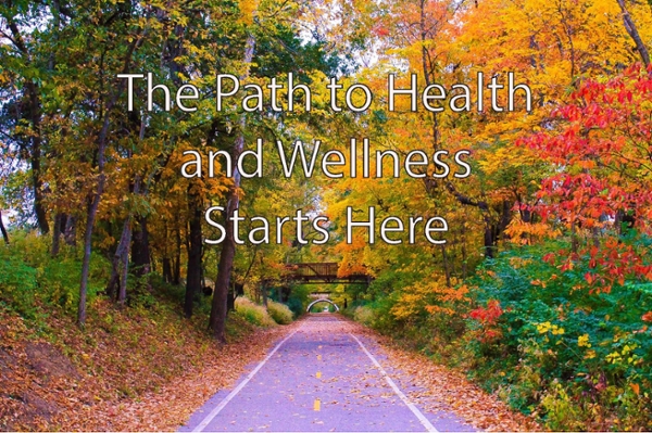 "The Path to Health and Wellness Starts Here" on a wooded path background