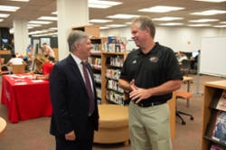 Photo of SIUE Chancellor Pembrook speaking with Edwardsville Mayor Patton
