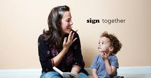  mother and toddler signing with word sign next to them 