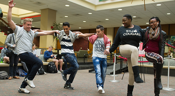 five students dancing in a line