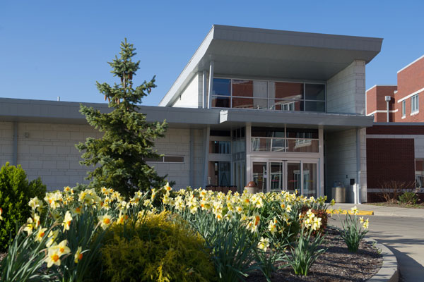 Photo of residence hall and spring flowers