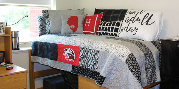 Photo of residence hall bed with SIUE decorations