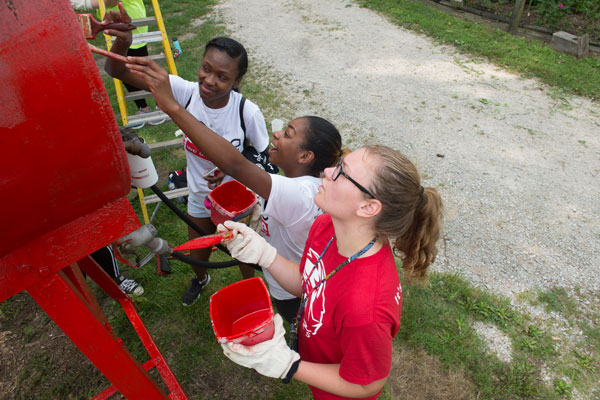 Students painting during a community service project