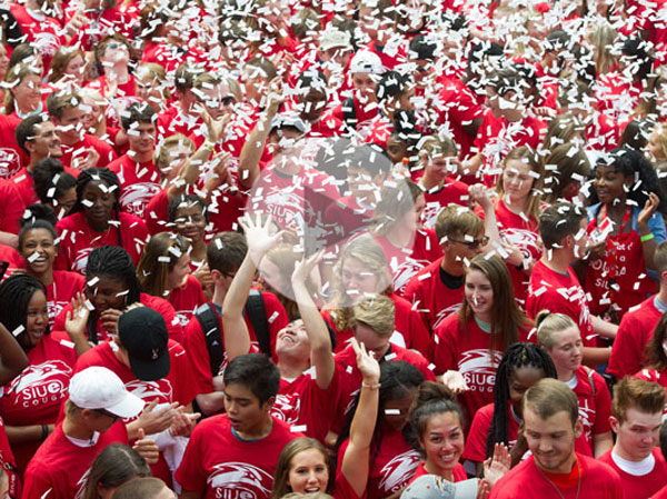 New students at the Cougar Statue with confetti with video play button