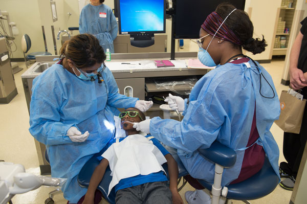 dental students with a patient