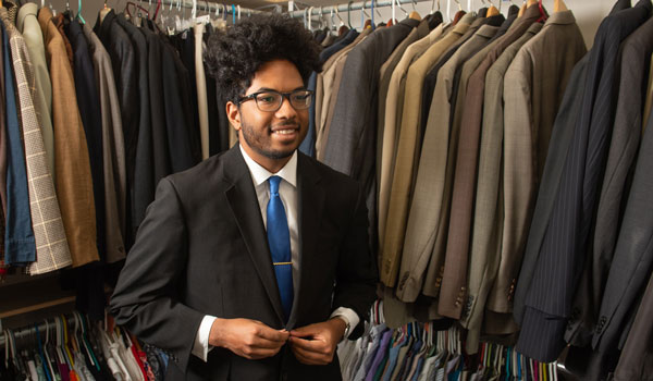 Student picking out a suit at the Cougar Career Closet