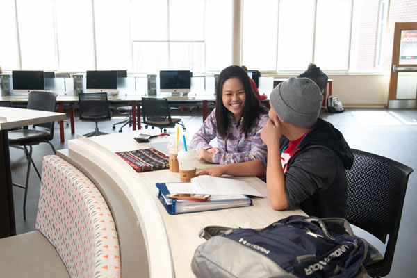 Students studying and laughing in the Student Success Center