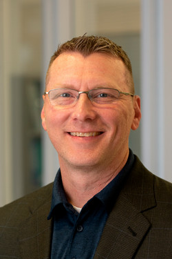 A portrait photo of Mark Ruscin