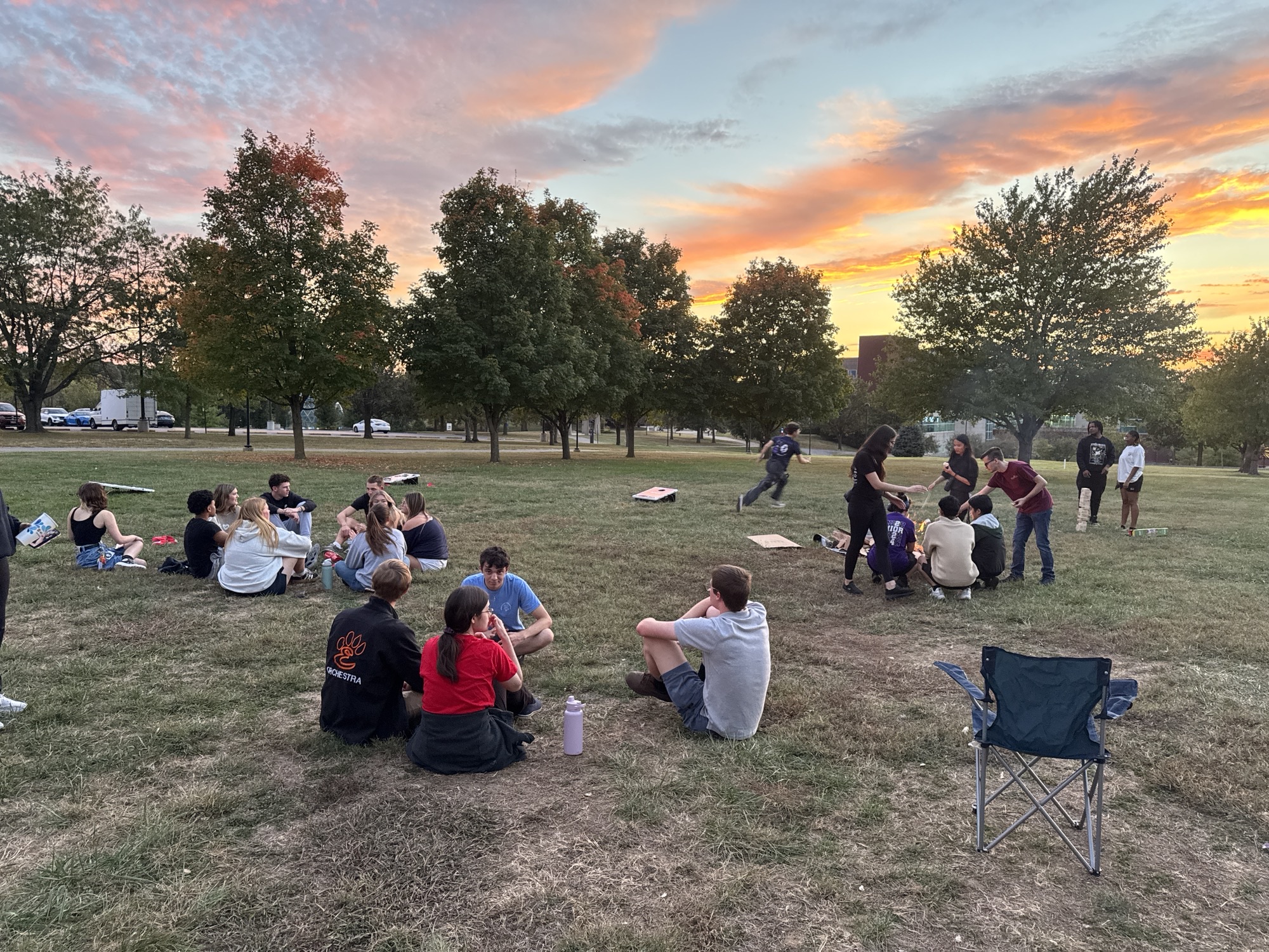 Students at the HSA bbq bonfire sitting in groups, smiling