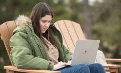 SIUE student works outside on campus.