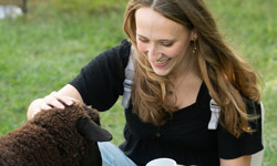 SIUE student pets a goat.