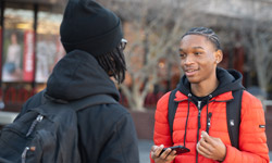 SIUE students talk outside a building.