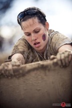 Melanie traversing a wall obstacle during a Spartan Race.