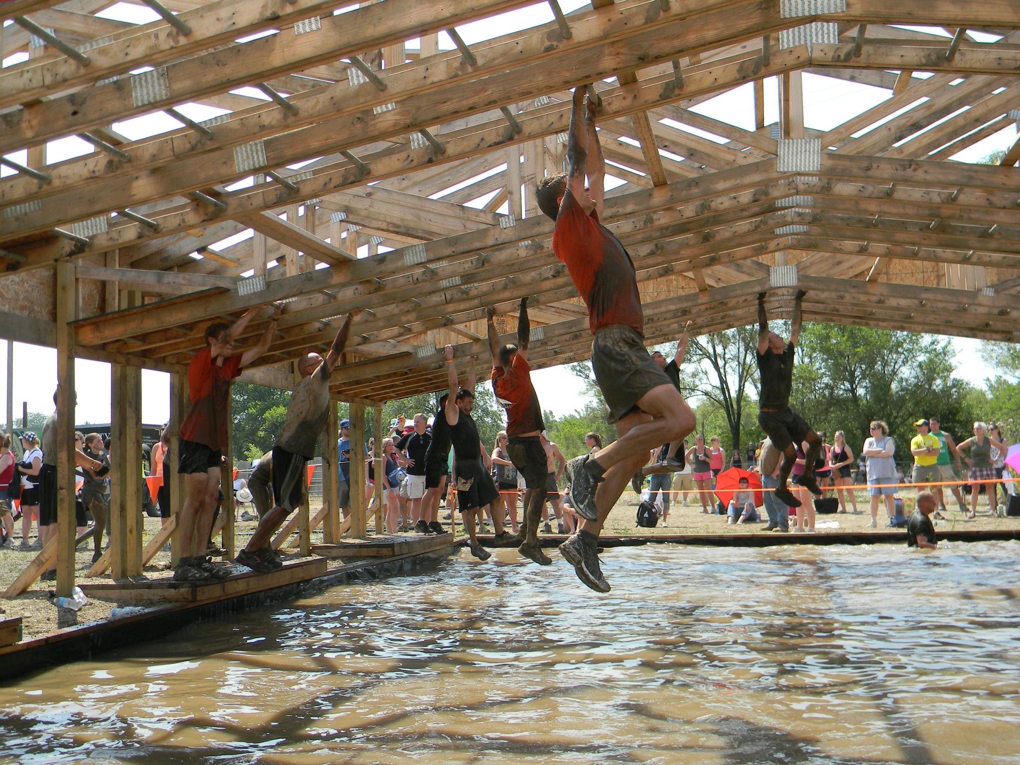 Monkey bars over water obstacle.