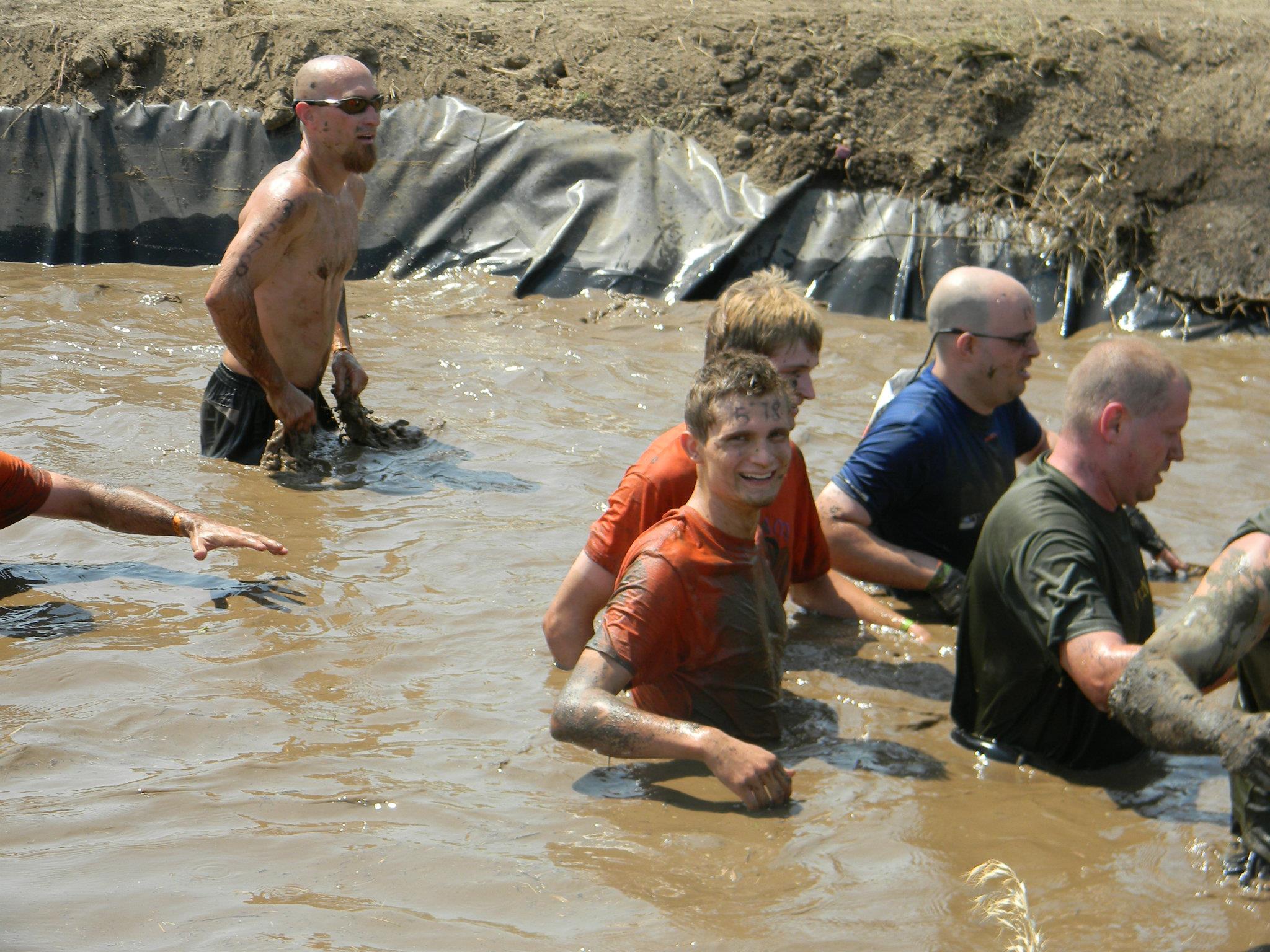 racers in muddy water obstacle